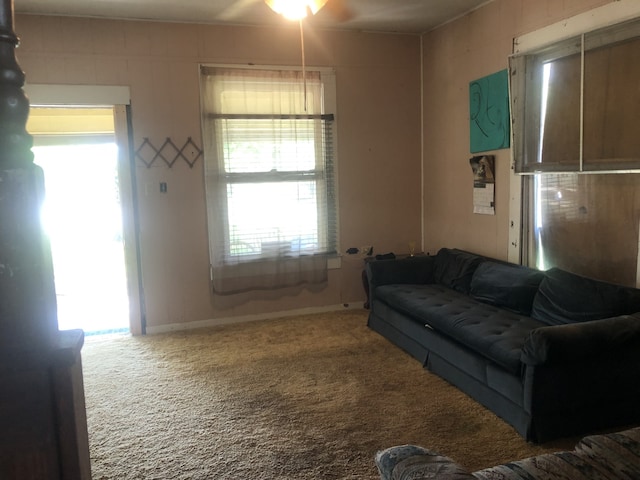 carpeted living room featuring ceiling fan