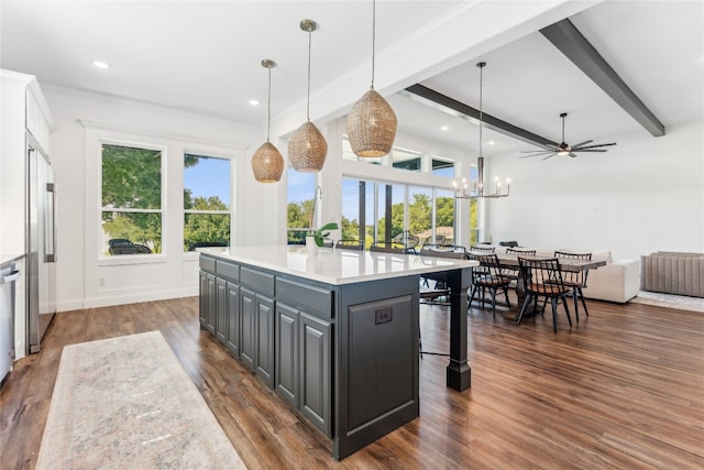 kitchen featuring a wealth of natural light, dark hardwood / wood-style flooring, and hanging light fixtures