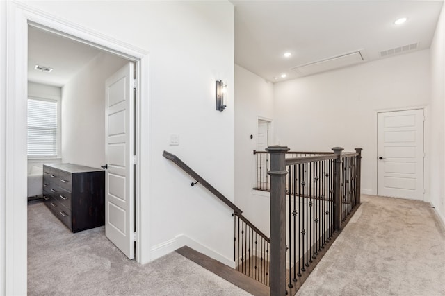 hallway featuring light colored carpet