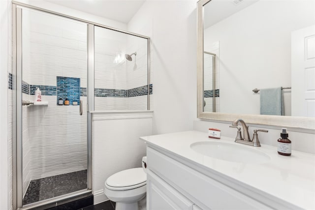 bathroom with a shower with door, toilet, oversized vanity, and tile flooring