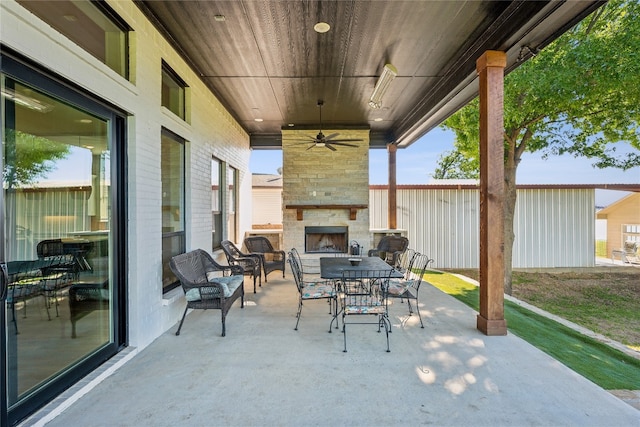 view of patio featuring an outdoor living space with a fireplace