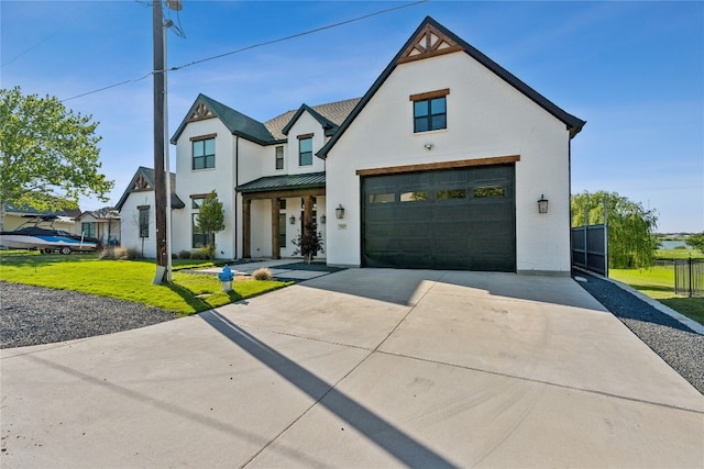 view of front of house featuring a garage and a front lawn