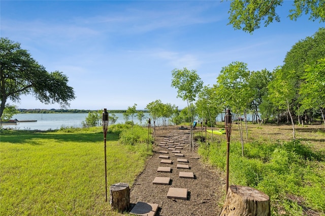 view of home's community with a yard and a water view