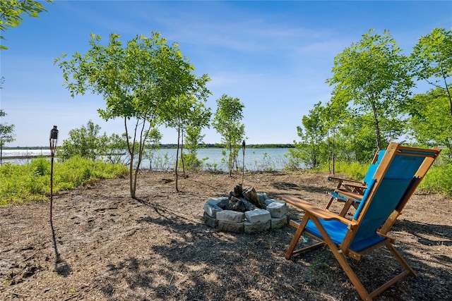 view of jungle gym with a fire pit and a water view