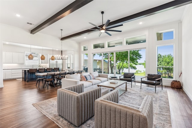 living room featuring beamed ceiling, ceiling fan, and dark hardwood / wood-style flooring