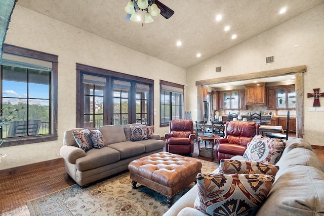 living room with high vaulted ceiling, ceiling fan, and plenty of natural light