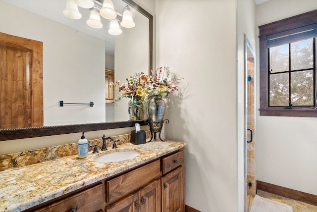 bathroom featuring vanity and an enclosed shower