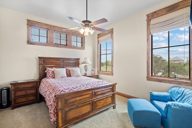 bedroom with light carpet and ceiling fan