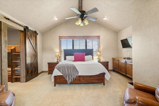 carpeted bedroom with lofted ceiling, a barn door, and ceiling fan