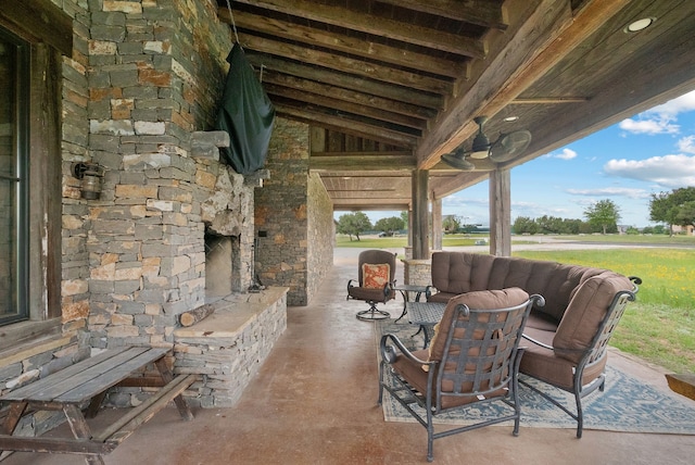 view of patio / terrace featuring an outdoor stone fireplace