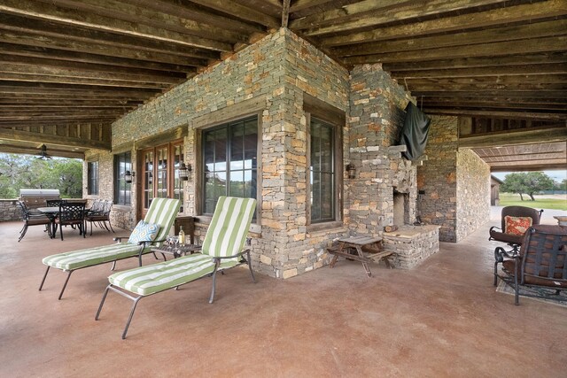 view of terrace featuring an outdoor living space with a fireplace