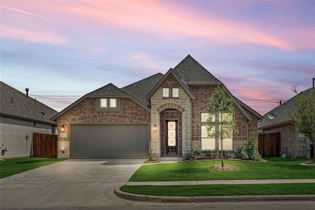 view of front facade with a lawn and a garage