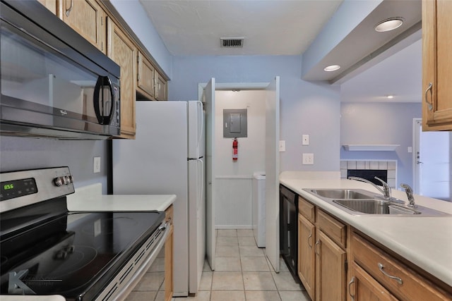 kitchen with black appliances, sink, and light tile flooring