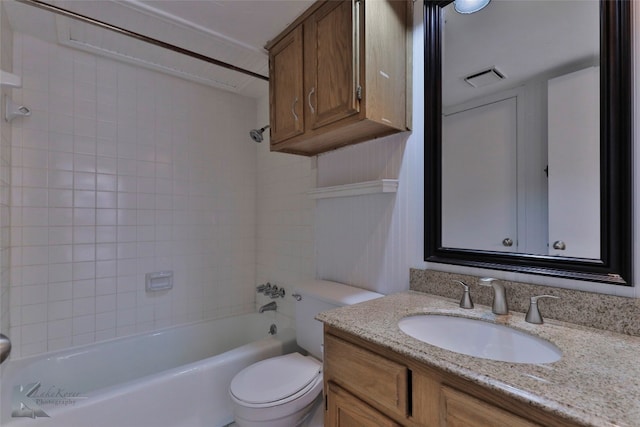 full bathroom featuring tiled shower / bath, toilet, and vanity