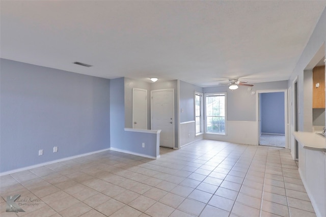 tiled empty room with ceiling fan