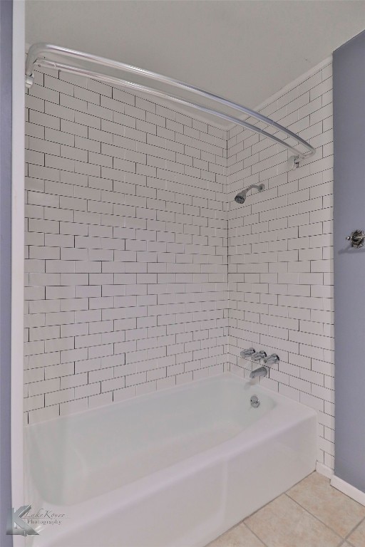 bathroom with tile flooring and tiled shower / bath combo