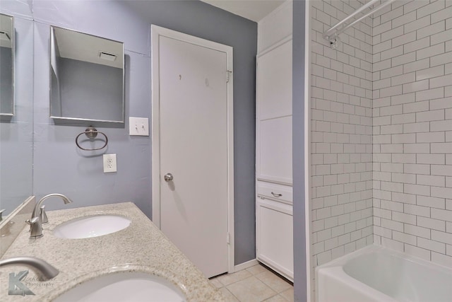 bathroom featuring tile flooring, dual sinks, tiled shower / bath combo, and large vanity