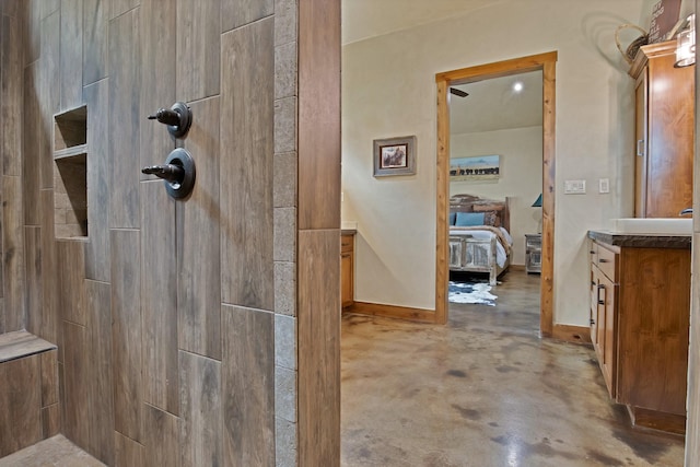 205 Haciendas Dr, Weatherford, TX 76087 - ensuite bathroom with tiled shower, vanity, and concrete floors