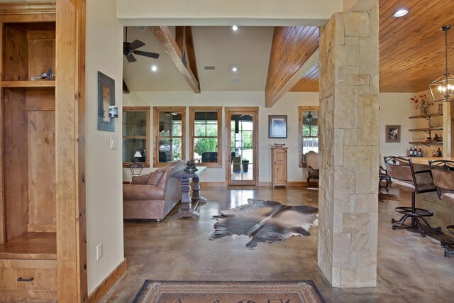 205 Haciendas Dr, Weatherford, TX 76087 - living area featuring ornate columns, finished concrete flooring, baseboards, ceiling fan, and wooden ceiling