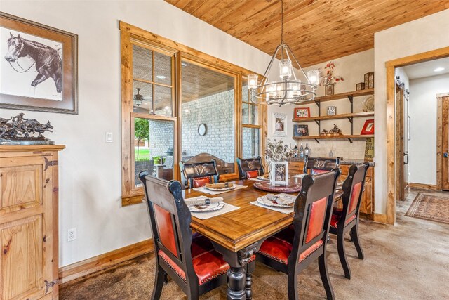 dining room featuring wooden ceiling, carpet, and an inviting chandelier