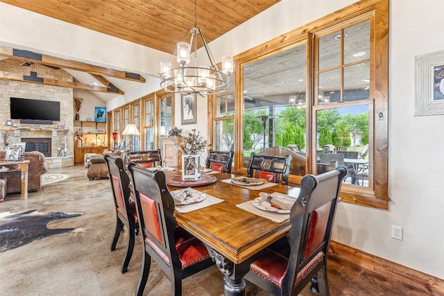 dining space featuring wooden ceiling, a chandelier, a towering ceiling, and a fireplace