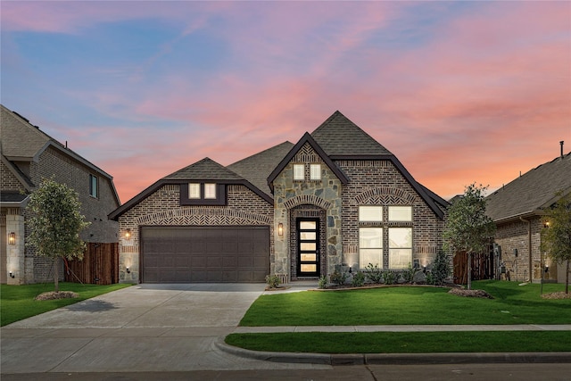 view of front facade with a garage and a lawn