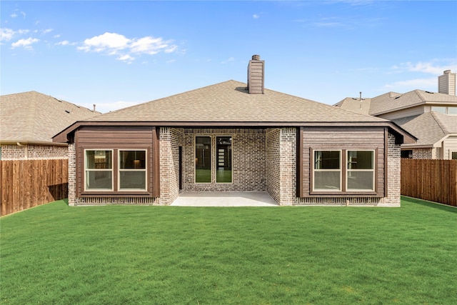 rear view of house featuring a yard and a patio area