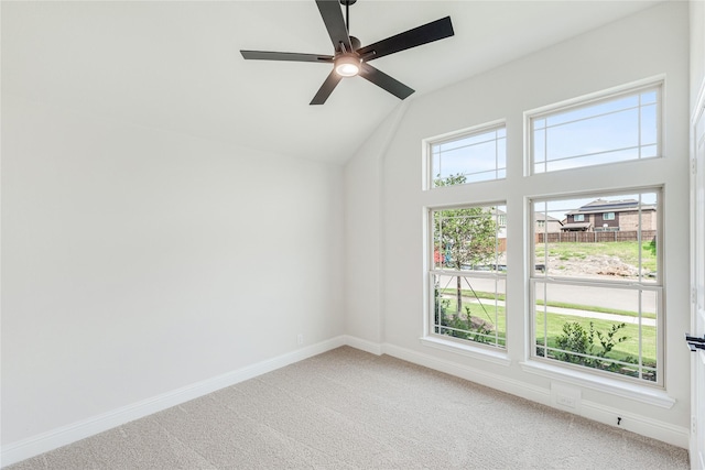 carpeted spare room featuring lofted ceiling and ceiling fan