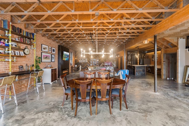 dining space featuring bar and brick wall