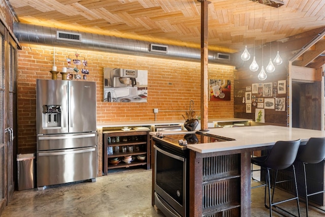 kitchen featuring brick wall, wood ceiling, stainless steel appliances, and decorative light fixtures