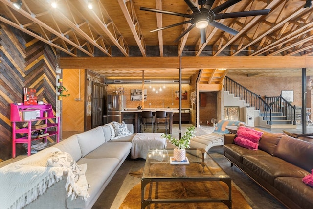 basement featuring brick wall, ceiling fan, and stainless steel fridge