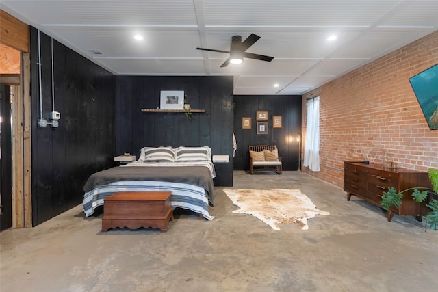 bedroom with ceiling fan, brick wall, and wooden walls