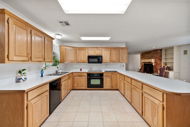 kitchen featuring black appliances, a fireplace, light tile patterned floors, sink, and kitchen peninsula