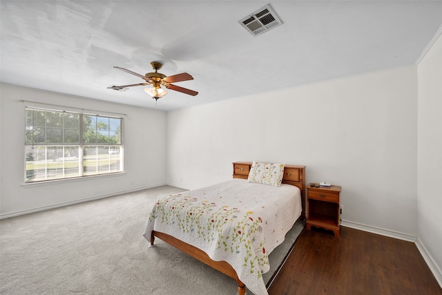 bedroom with dark wood-type flooring and ceiling fan