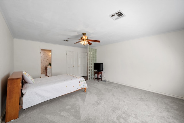 bedroom featuring ensuite bathroom, carpet, and ceiling fan