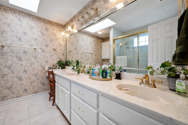 bathroom with vanity, walk in shower, tile patterned floors, and a skylight