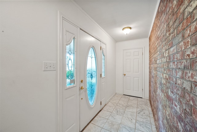 entryway with brick wall and crown molding