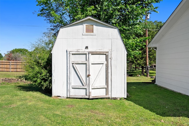 view of outbuilding featuring a lawn