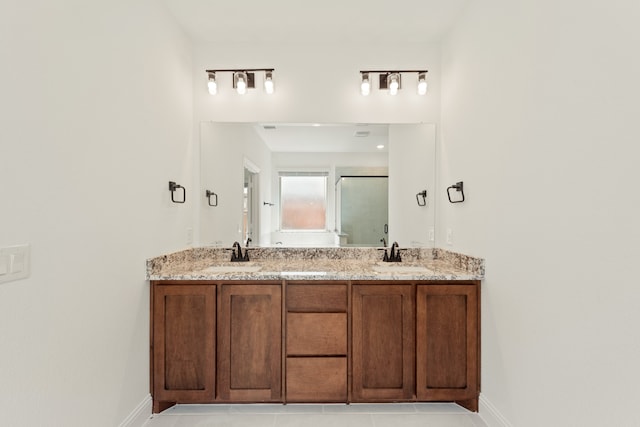 bathroom featuring walk in shower, vanity, and tile patterned floors