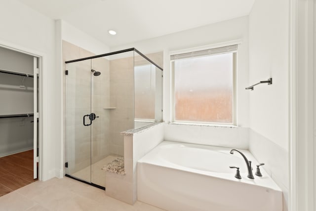 bathroom featuring tile patterned flooring and independent shower and bath