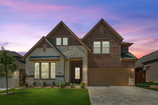 view of front of property with a garage and a lawn