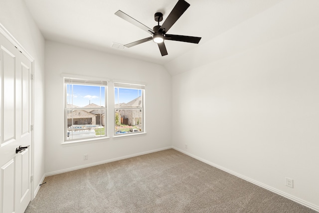 unfurnished room featuring light carpet, vaulted ceiling, and ceiling fan