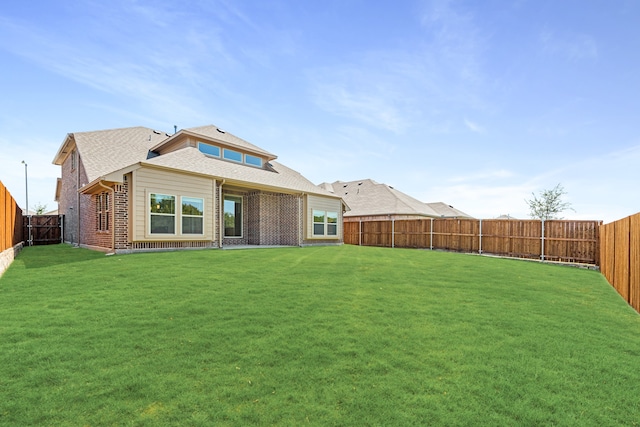 rear view of property featuring a lawn