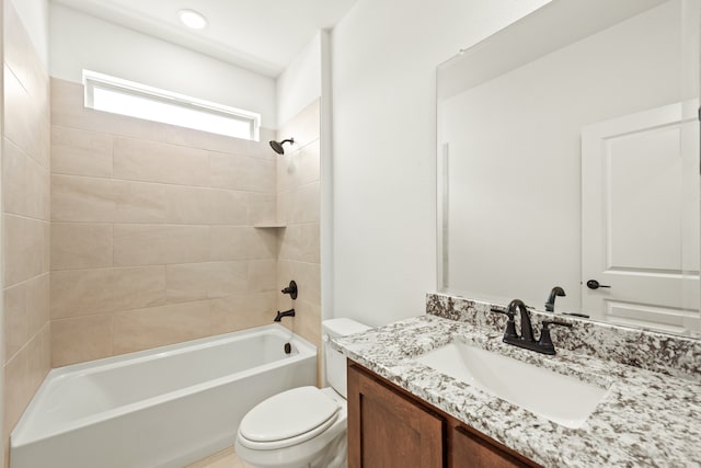 full bathroom with tiled shower / bath combo, vanity, and toilet