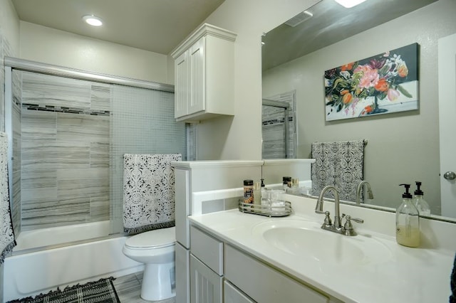 full bathroom featuring enclosed tub / shower combo, tile floors, vanity, and toilet