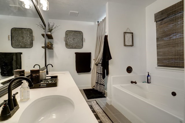 bathroom with dual sinks, oversized vanity, a tub, and tile floors