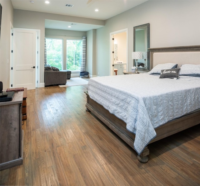 bedroom with hardwood / wood-style flooring