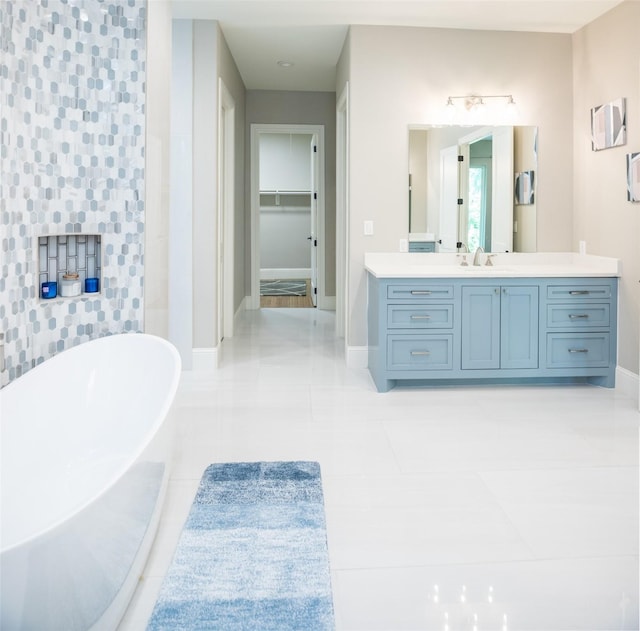 bathroom featuring vanity, a tub, and tile patterned floors