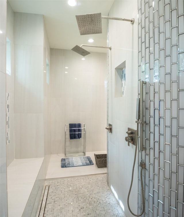 bathroom with tiled shower, tile patterned flooring, and heating unit