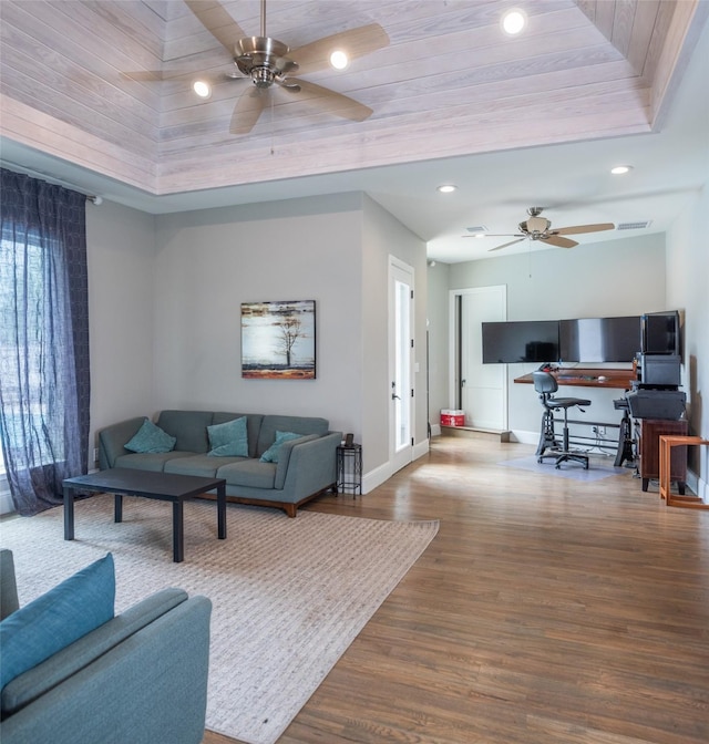 living room featuring ceiling fan and wood-type flooring